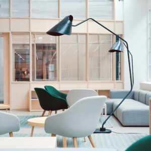 Arc floor lamp beside accent chairs in a bright living room