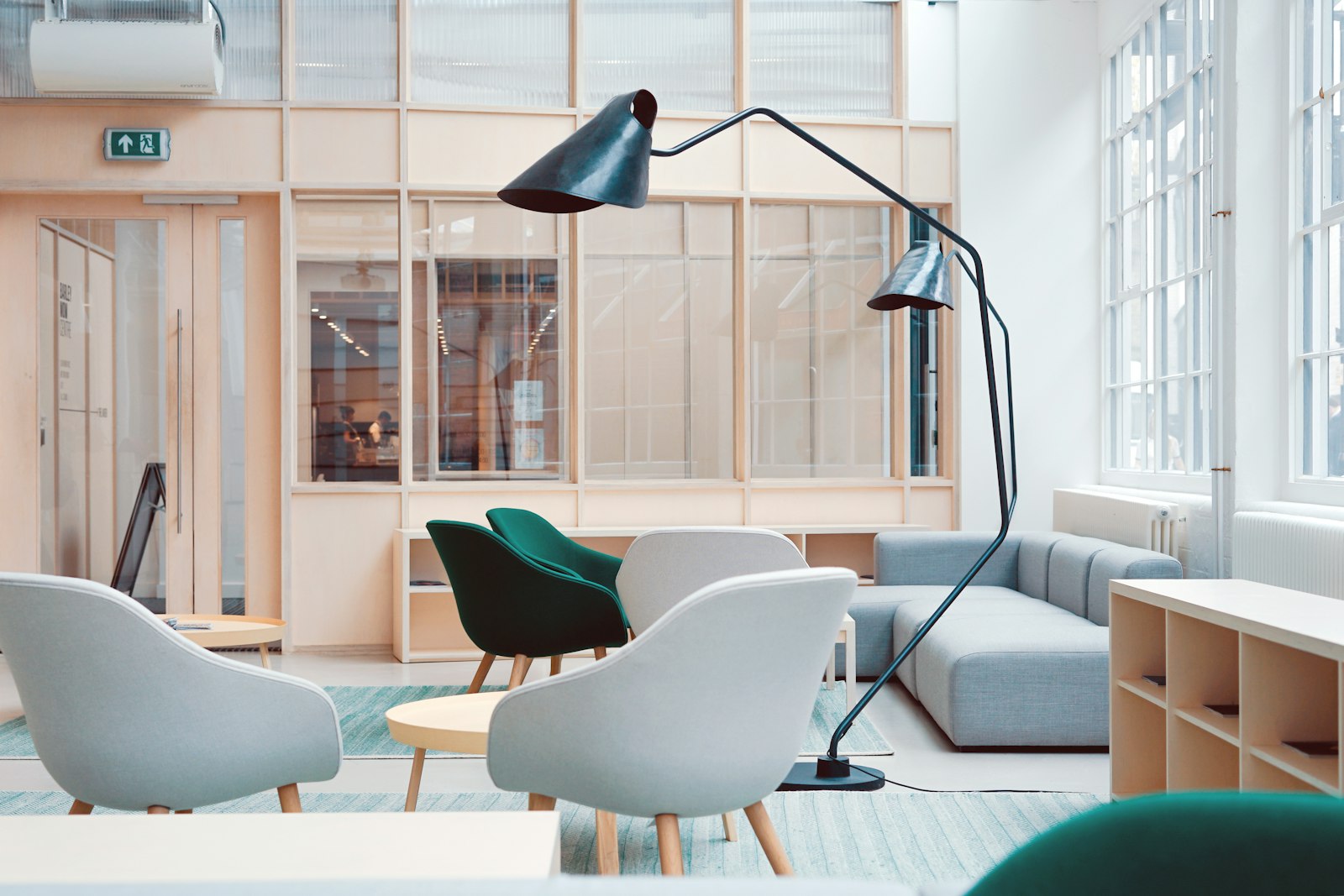 Arc floor lamp beside accent chairs in a bright living room