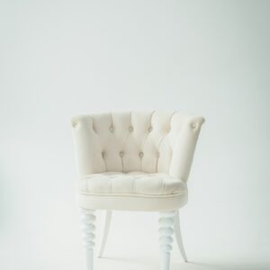 Ivory boucle accent chair on a plain background