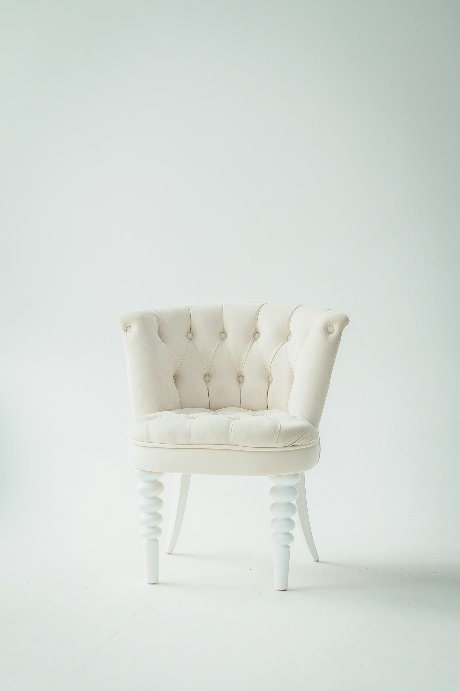 Ivory boucle accent chair on a plain background