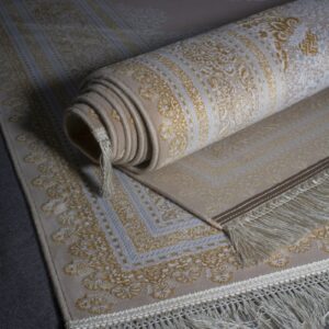 Hand-loomed area rug rolled on a wooden floor