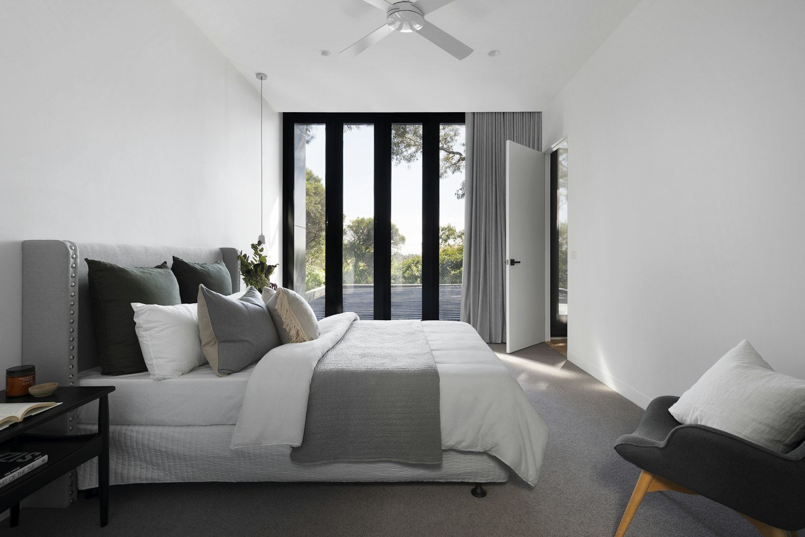 Serene bedroom with an upholstered platform bed and soft grey bedding